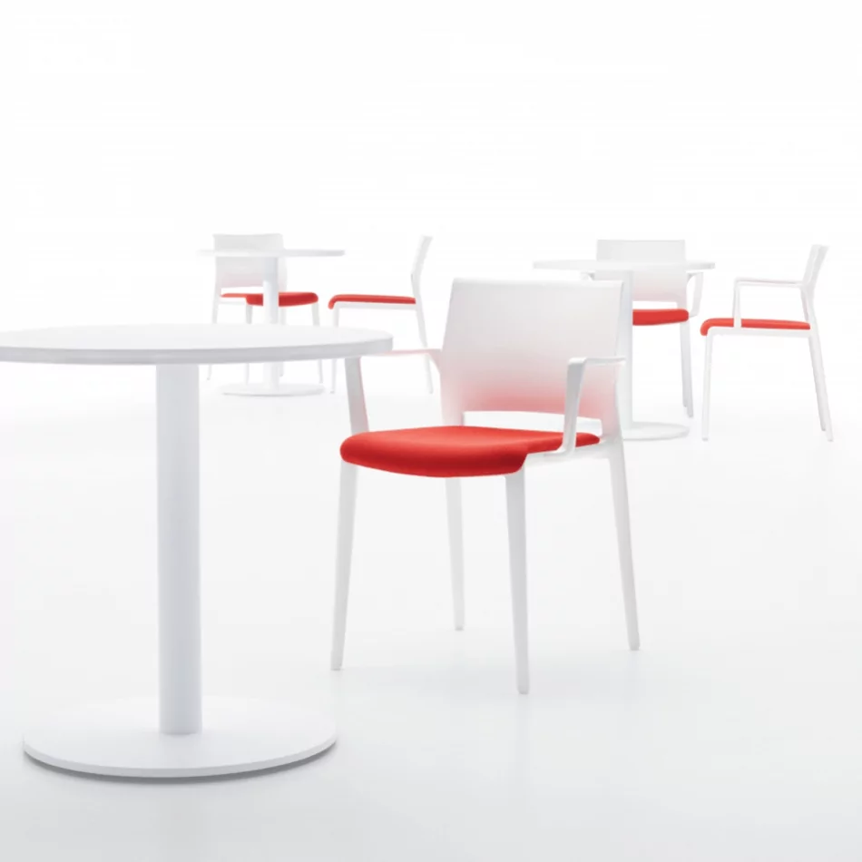 Bakhita Cafe Lunchroom Chair Stool 2 with red seat cushions and white frames, arranged around a round white table in a minimalist setting, ideal for cafe and lunchroom environments.