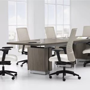 Synopsis Conference Executive Chair 3 in a modern conference room setting, featuring ergonomic design and adjustable features, surrounded by additional chairs and a sleek table.