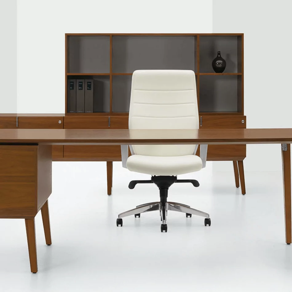Single Desk 9 featuring a wooden desk and a modern white office chair, set against a minimalist backdrop with a storage unit and decorative items.