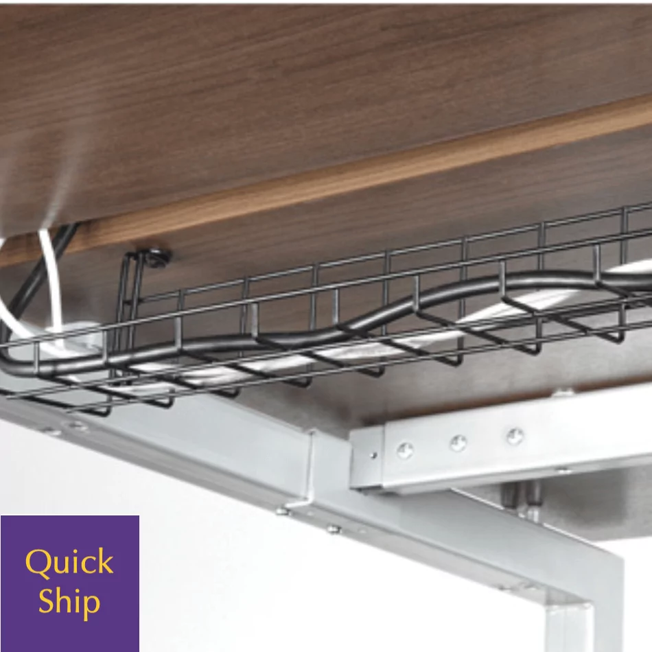 Wire management system under a wooden tabletop, featuring a black metal cable tray, with visible electrical cords and a "Quick Ship" label in the corner.