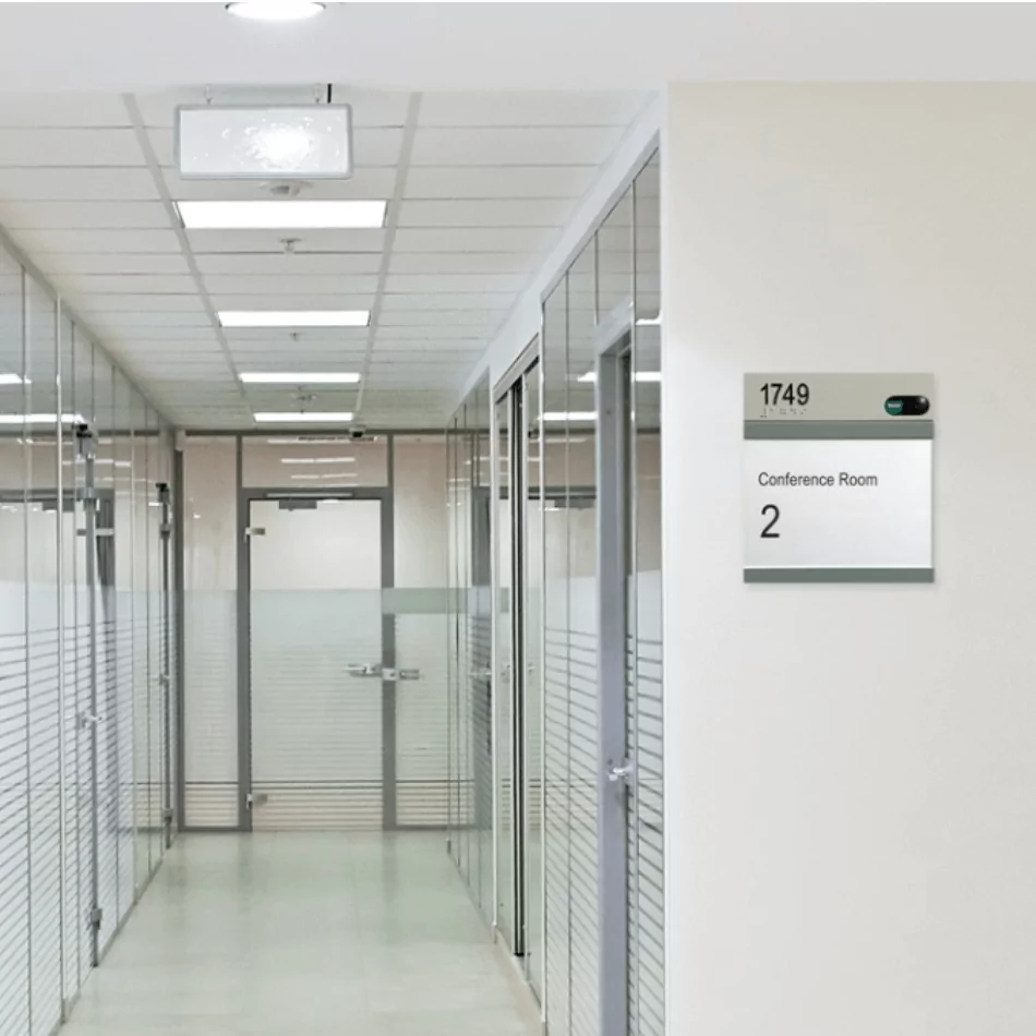 Wall plaque displaying "Conference Room 2" with the number "1749," located in a modern office corridor.