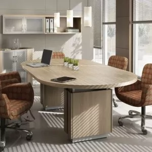 Modern conference table with ergonomic chairs in a well-lit office setting, featuring a sleek design and natural wood finish, ideal for meetings and collaborative workspaces.