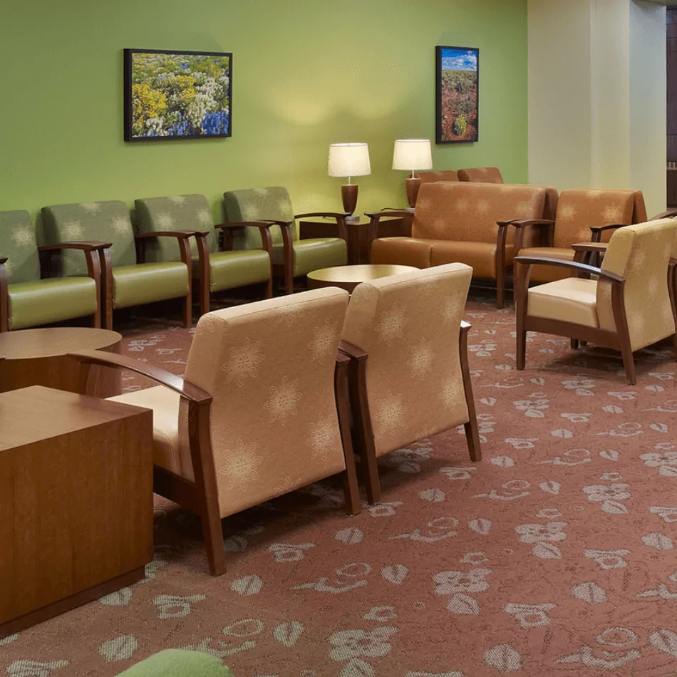 Globalcare Lounge Reception Collaborative Seating arranged in a welcoming lounge area with green walls, soft lighting, and decorative artwork.
