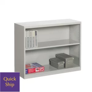Low metal bookcase with two shelves, featuring storage boxes and binders, labeled "Quick Ship," relevant to the "Lockers 2" storage solutions offered by Furniture Soup.