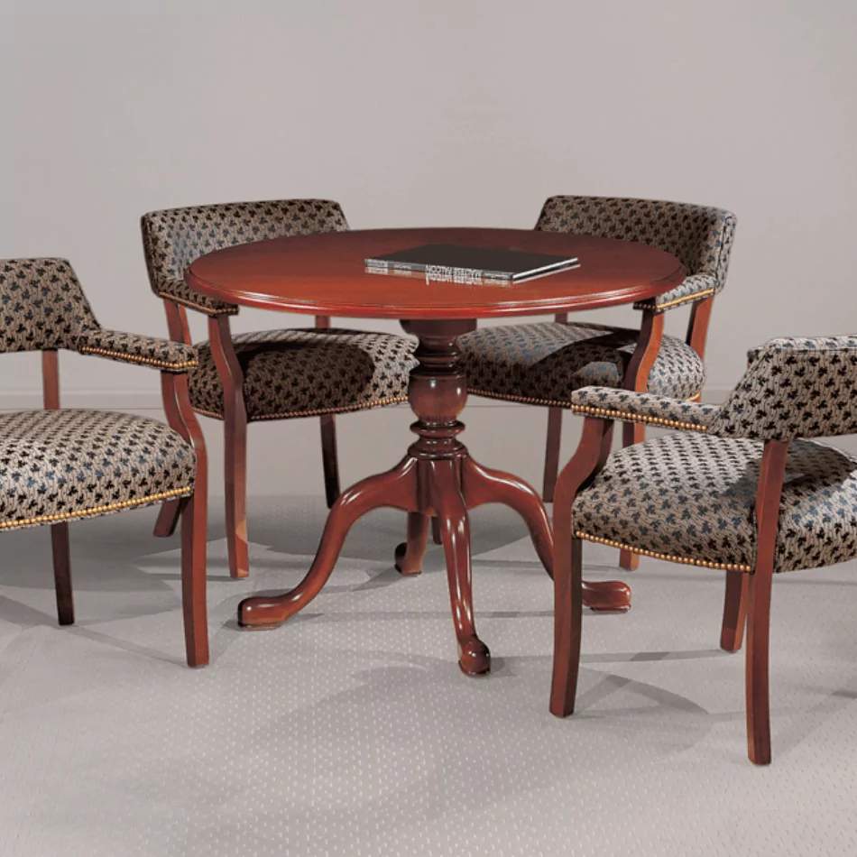 Madison guest and meeting chairs with a round wooden table, featuring patterned upholstery and a polished finish, suitable for office or reception areas.
