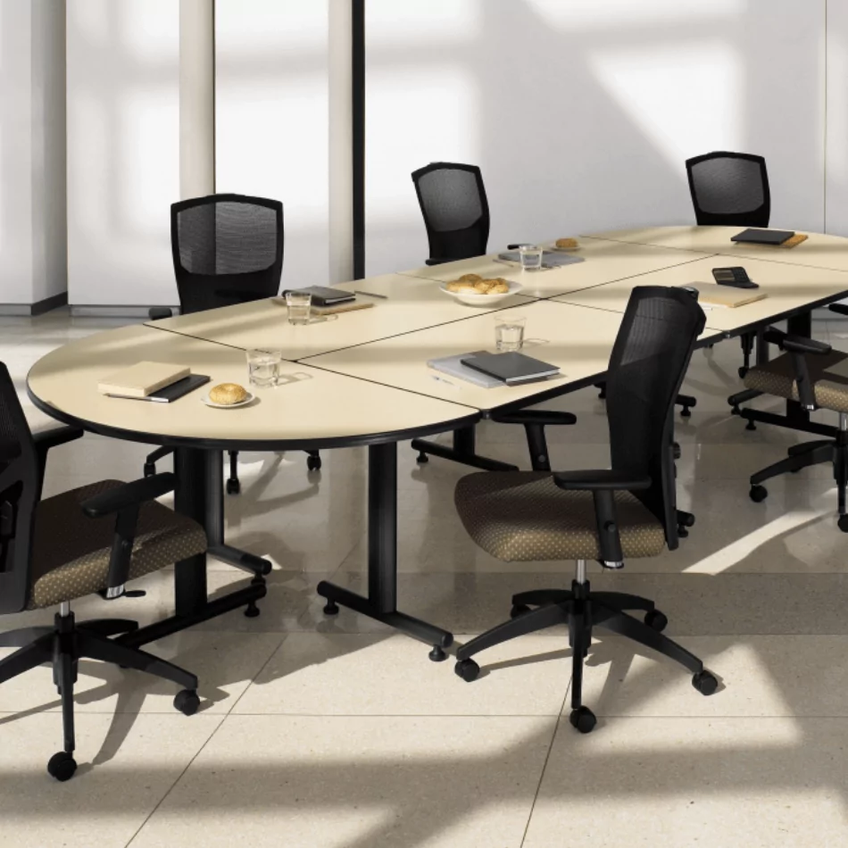 Training table with beige top, surrounded by black mesh chairs, in a modern office setting, showcasing a professional workspace ideal for meetings and training sessions.