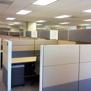 Used Herman Miller Ethospace cubicles in an office setting, featuring neutral-colored partitions and workstations, highlighting the layout of available used office furniture.
