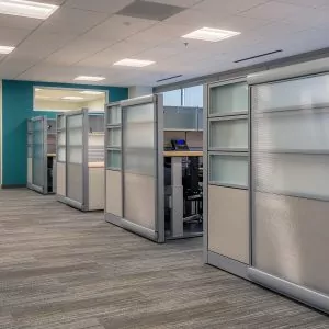 Cubicles in modern office setting featuring New Cubicle Global Evolve 9 design, showcasing sleek panels and organized workspaces.