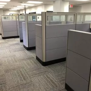 Used cubicles in an office setting featuring Herman Miller Ethospace design, with gray partitions and glass panels, suitable for workspace organization.