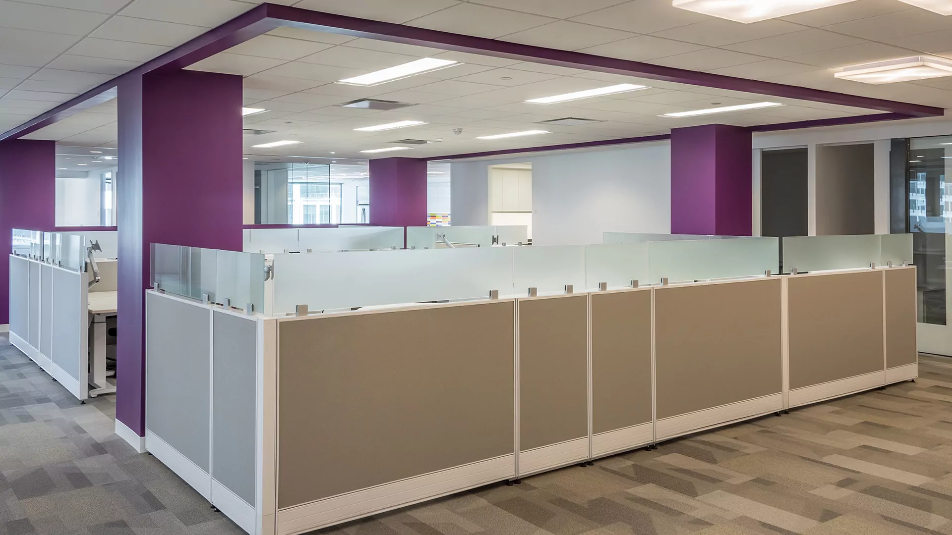 Modern office cubicle layout featuring the New Cubicle Global Compile 7 design, with frosted glass panels and neutral color scheme, set in a spacious workspace.