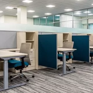New Cubicle Global Evolve 6 office workspace featuring modern cubicles with blue and gray partitions, ergonomic chairs, and desks, designed for optimal productivity in office environments.